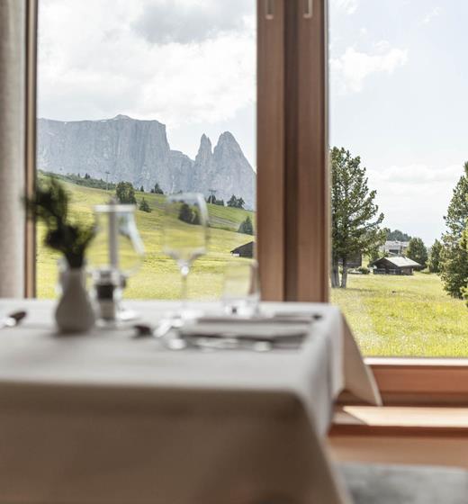 A table in the dining room with a view on the Seiser Alm