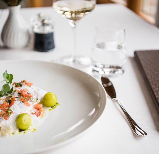 Tender fish with foam, diced tomatoes and vegetable spheres