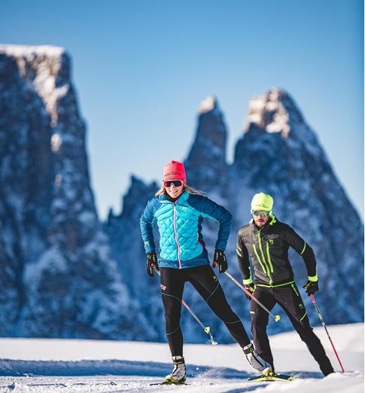 Two people are cross-country skiing